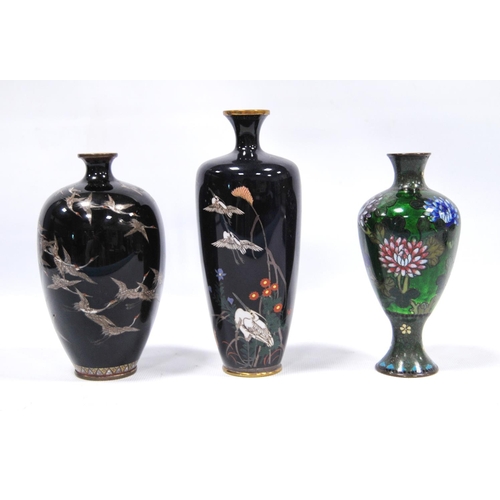 179 - Three cloisonné vases, two with black ground decorated with cranes, the third with green ground, chr... 