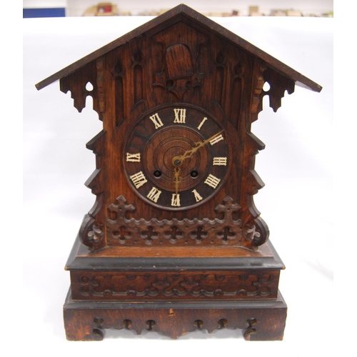 222 - Black Forest cuckoo clock with fretwork pediment over turned face, Roman numerals, flanked by carved... 