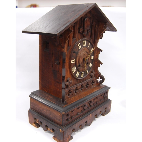 222 - Black Forest cuckoo clock with fretwork pediment over turned face, Roman numerals, flanked by carved... 