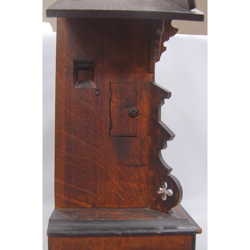 222 - Black Forest cuckoo clock with fretwork pediment over turned face, Roman numerals, flanked by carved... 