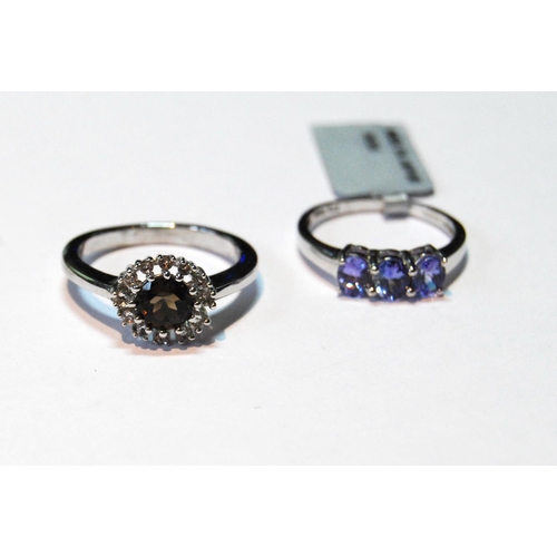 27 - Tanzanite three-stone ring and another, smoky quartz, in 9ct white gold, sizes N and P.   (2)