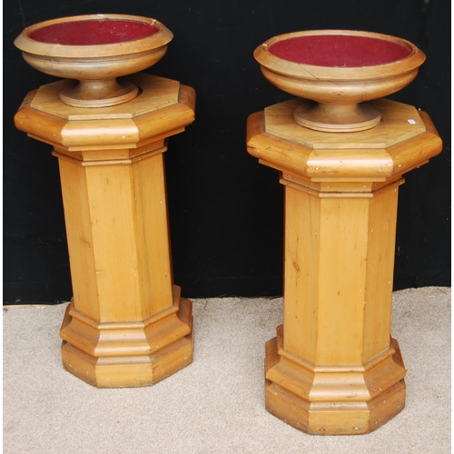 346 - Pair of octagonal pine columns, each with moulded top and plinth base and collection bowls, 73cm hig... 