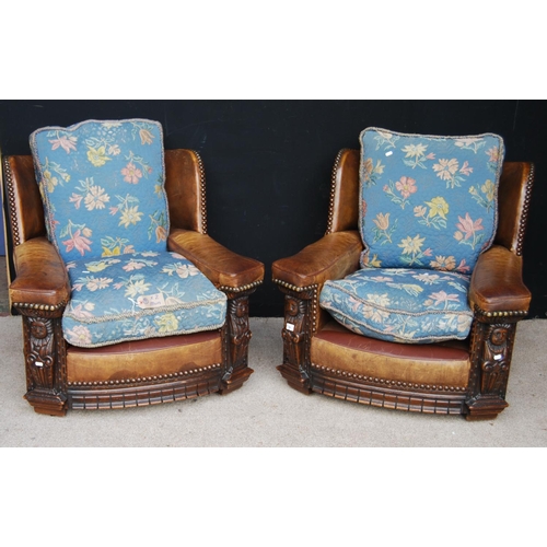 348 - Pair of leather armchairs, each with loose cushion seats and frieze carved panels, 88cm wide, 77cm h... 