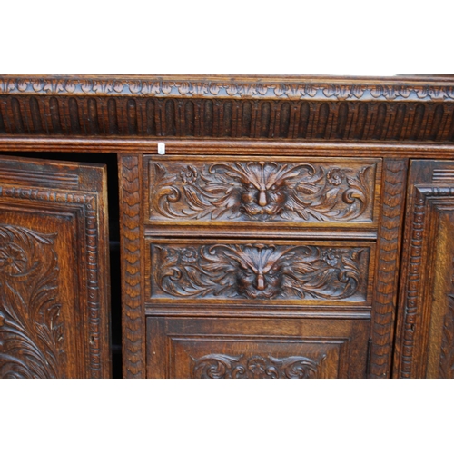 353 - Large late Victorian oak sideboard, the projected moulded cornice over carved frieze, mirrored back ... 