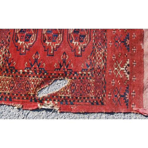 354 - Afghan rug with three rows of three guls and stars over red ground and border, 150cm x 107cm.