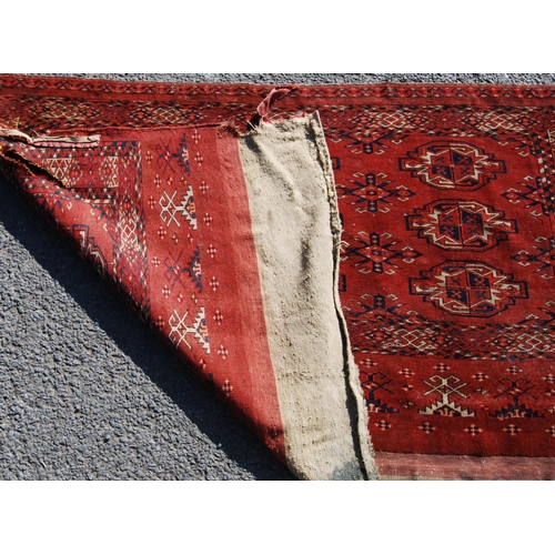 354 - Afghan rug with three rows of three guls and stars over red ground and border, 150cm x 107cm.