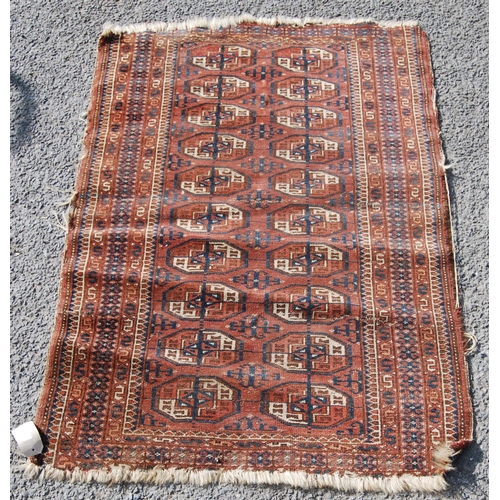 357 - Afghan rug with two rows of ten guls over red ground and geometric border, 135cm x 93cm.