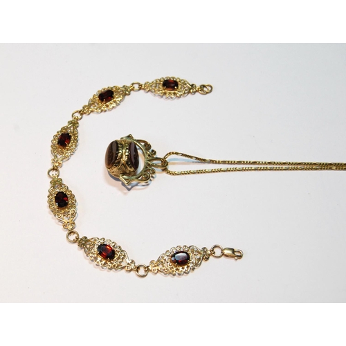 36 - Gold swivel seal pendant, with necklet, and a garnet bracelet, both 9ct gold, 17.5g.