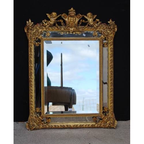 364 - 19th century gilt wall mirror mounted by cartouche flanked by cherubs, cushioned bevelled glass plat... 