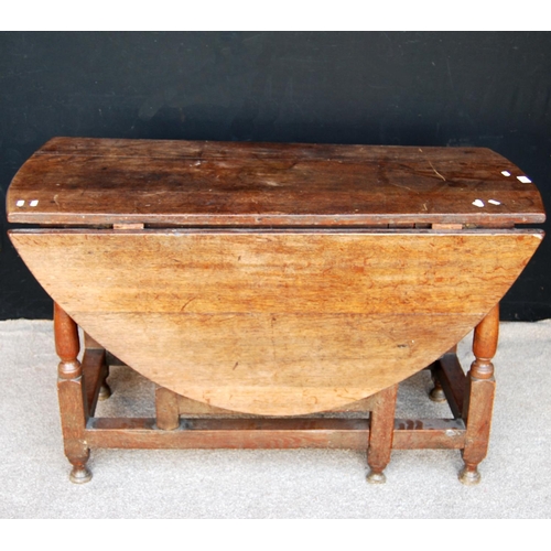 368 - Oak gateleg table, the oval top raised on block and baluster turned legs united by stretcher, 119cm ... 