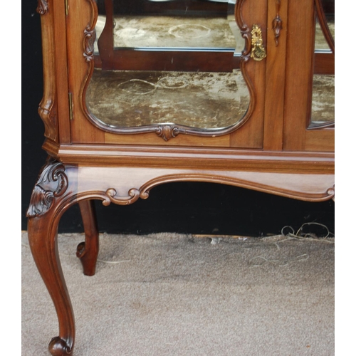 369 - Late 19th century mahogany display cabinet, the projected cornice over stepped top, glazed door encl... 