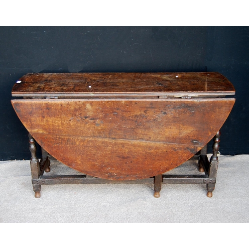 373 - Late 17th or early 18th century oak gateleg table, the oval drop flap top raised on block and turned... 