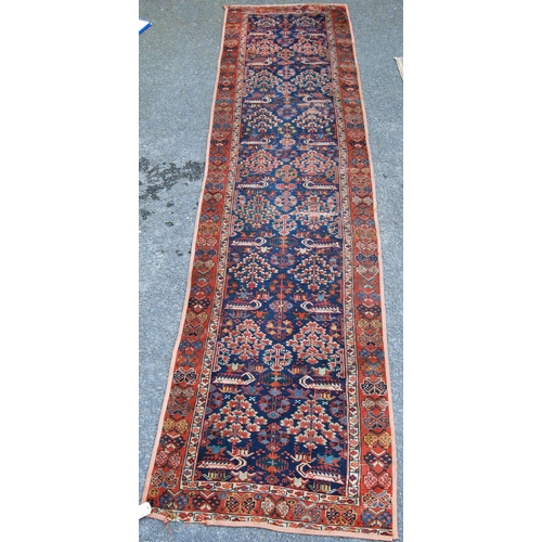 383 - Turkish runner with two rows of floral diamonds, blue ground, red and floral border, 395cm x 95cm.