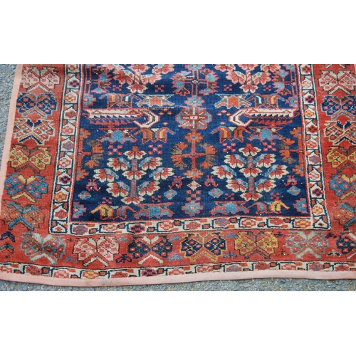 383 - Turkish runner with two rows of floral diamonds, blue ground, red and floral border, 395cm x 95cm.