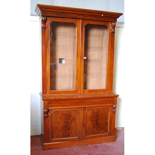 384 - Victorian mahogany bookcase cabinet, the projected cornice over glazed doors enclosing shelves, flan... 