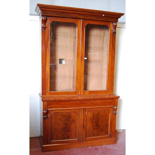 384 - Victorian mahogany bookcase cabinet, the projected cornice over glazed doors enclosing shelves, flan... 