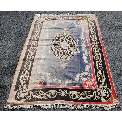 386 - Eastern rug with central floral lozenge over faded blue ground, black and pink floral border, 270cm ... 