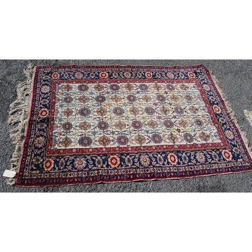 388 - Persian rug with five rows of eleven alternating rosettes over cream ground, floral red and blue bor... 