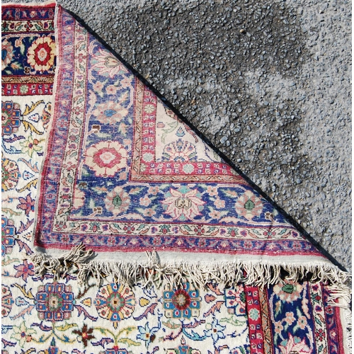 388 - Persian rug with five rows of eleven alternating rosettes over cream ground, floral red and blue bor... 