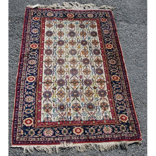 388 - Persian rug with five rows of eleven alternating rosettes over cream ground, floral red and blue bor... 