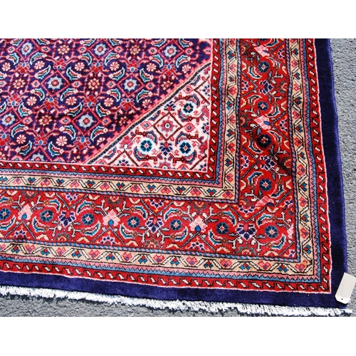 389 - Persian carpet with central red diamond over blue ground, all over geometric floral design, spandrel... 