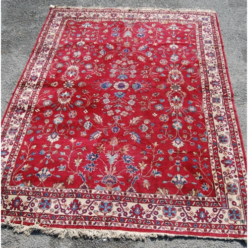 390 - Persian style carpet with all over floral design over red ground and alternate cream floral borders,... 