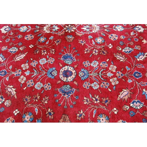 390 - Persian style carpet with all over floral design over red ground and alternate cream floral borders,... 