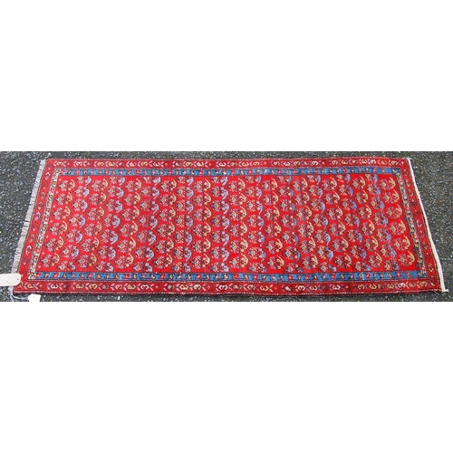 391 - Mir Serabend rug with all over floral boteh design over red ground and double border, 154cm x 58cm.