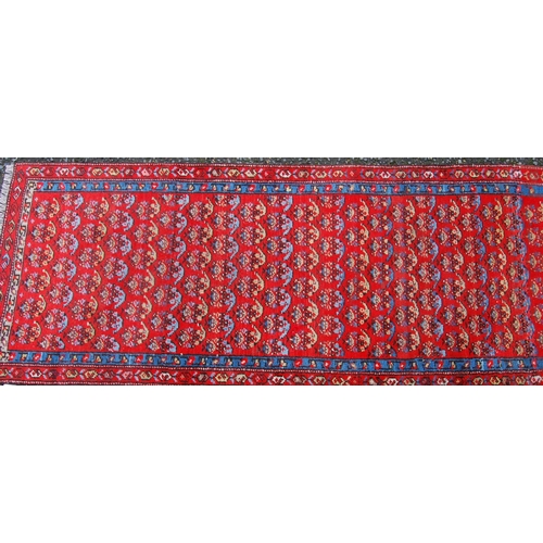 391 - Mir Serabend rug with all over floral boteh design over red ground and double border, 154cm x 58cm.