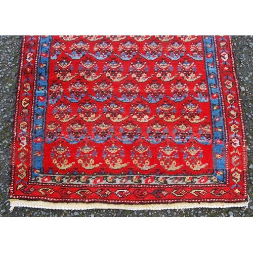 391 - Mir Serabend rug with all over floral boteh design over red ground and double border, 154cm x 58cm.