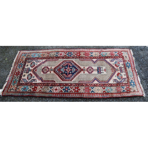 394 - Kurdish rug with central medallion, geometric design over cream ground and cruciform border, 175cm x... 