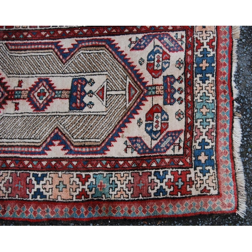 394 - Kurdish rug with central medallion, geometric design over cream ground and cruciform border, 175cm x... 