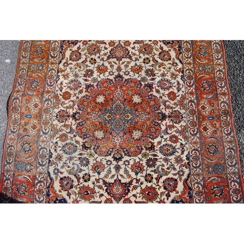 395 - Persian rug with central medallion, all over floral design, cream ground, spandrels and triple borde... 