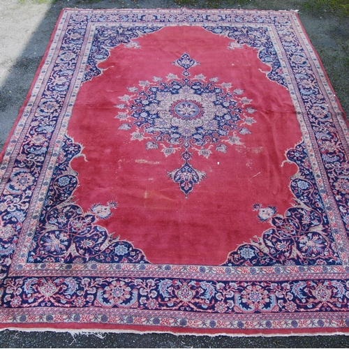 396 - Persian style carpet with central medallion over red ground, spandrels and foliate border, 303cm x 4... 