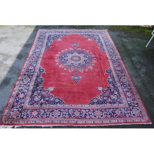 396 - Persian style carpet with central medallion over red ground, spandrels and foliate border, 303cm x 4... 