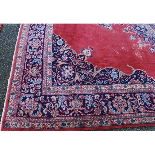 396 - Persian style carpet with central medallion over red ground, spandrels and foliate border, 303cm x 4... 