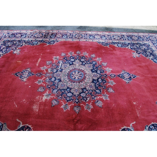 396 - Persian style carpet with central medallion over red ground, spandrels and foliate border, 303cm x 4... 