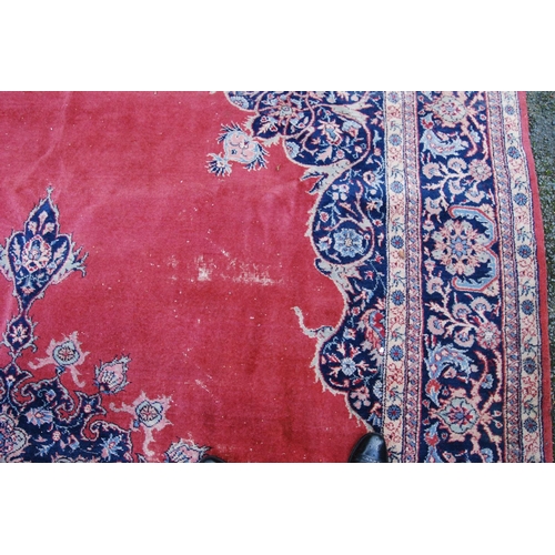 396 - Persian style carpet with central medallion over red ground, spandrels and foliate border, 303cm x 4... 