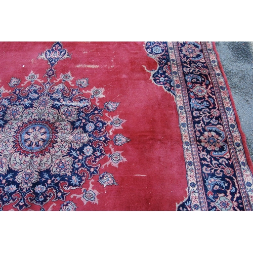 396 - Persian style carpet with central medallion over red ground, spandrels and foliate border, 303cm x 4... 