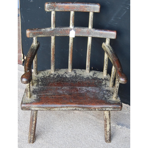 398 - Primitive Welsh style stick back chair, the stepped top rail over serpentine arms and solid seat, ra... 