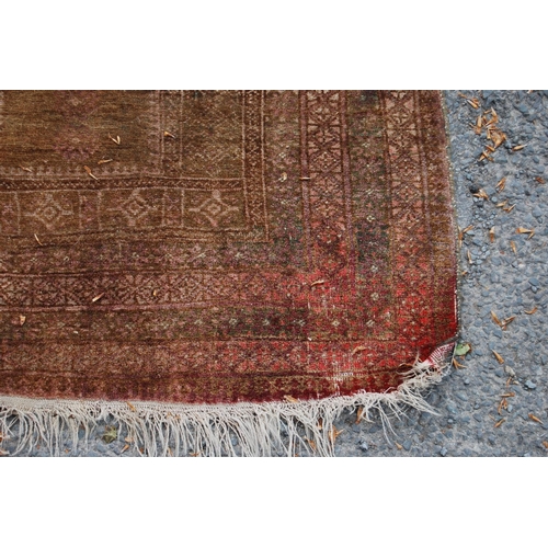 402 - Prayer mat with triple mihrab panel over mihrab, group border, faded red ground, 137cm x 68cm.