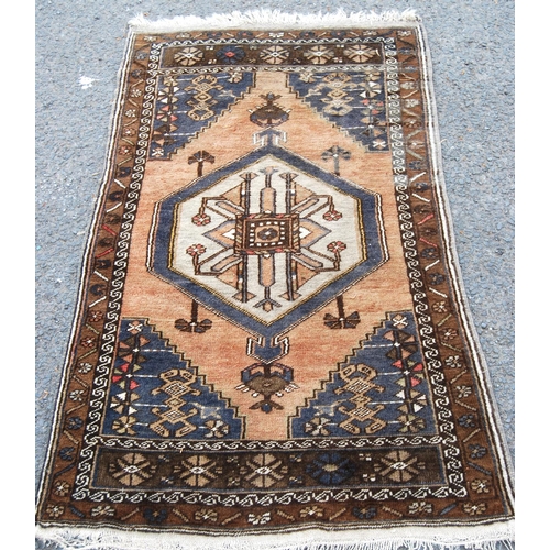 403 - Persian rug with central medallion over brown ground, spandrels and floral border, 138cm x 78cm.