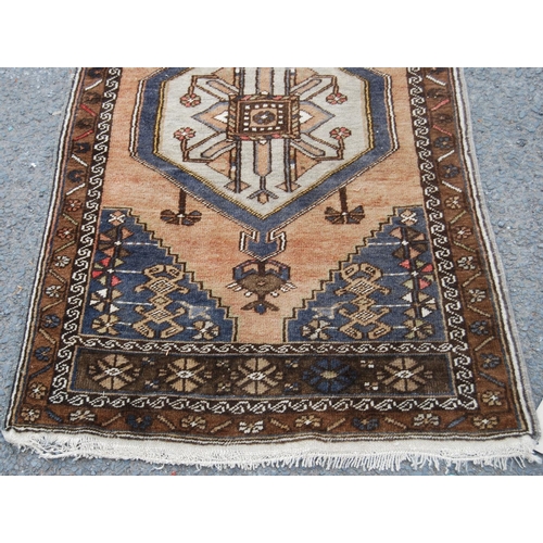 403 - Persian rug with central medallion over brown ground, spandrels and floral border, 138cm x 78cm.