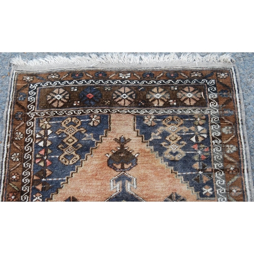 403 - Persian rug with central medallion over brown ground, spandrels and floral border, 138cm x 78cm.