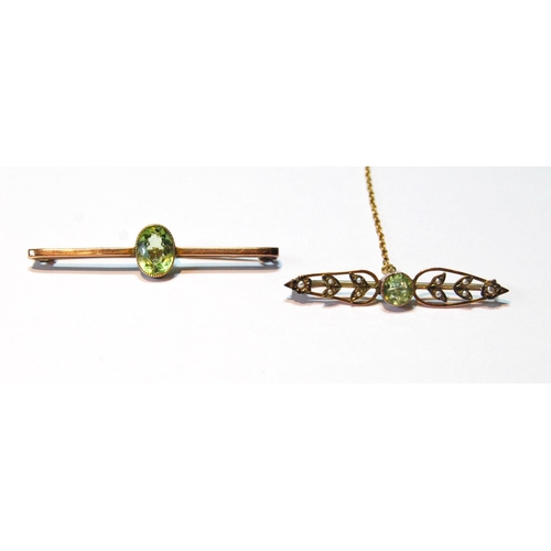 74 - Two peridot bar brooches in gold.