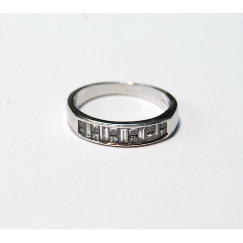 79 - Diamond half eternity ring, princess and baguette-cut, in 18ct white gold, size L, 2.7g.