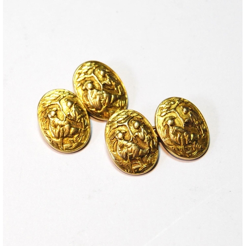 91 - Pair of Chinese gold cufflinks, oval, embossed with figures, now with brass chains, gross 8.7g.