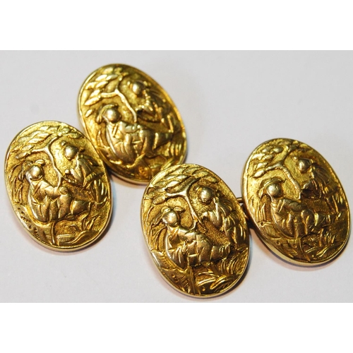 91 - Pair of Chinese gold cufflinks, oval, embossed with figures, now with brass chains, gross 8.7g.