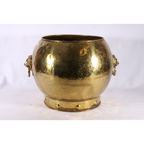 307 - Arts and Crafts style brass log bin of circular form with lion mask and ring handles raised on a col... 