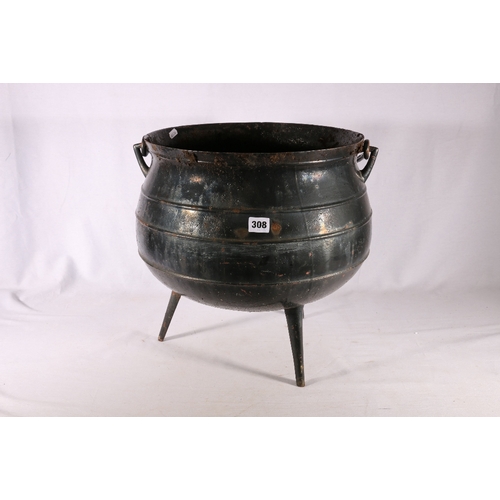 308 - Heavy wrought iron cauldron with twist swing handle raised on three stick feet, 38cm diameter